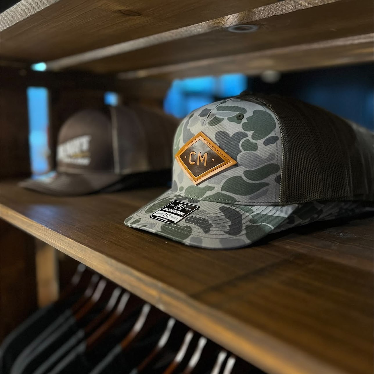 Camo CM hat on shop shelf